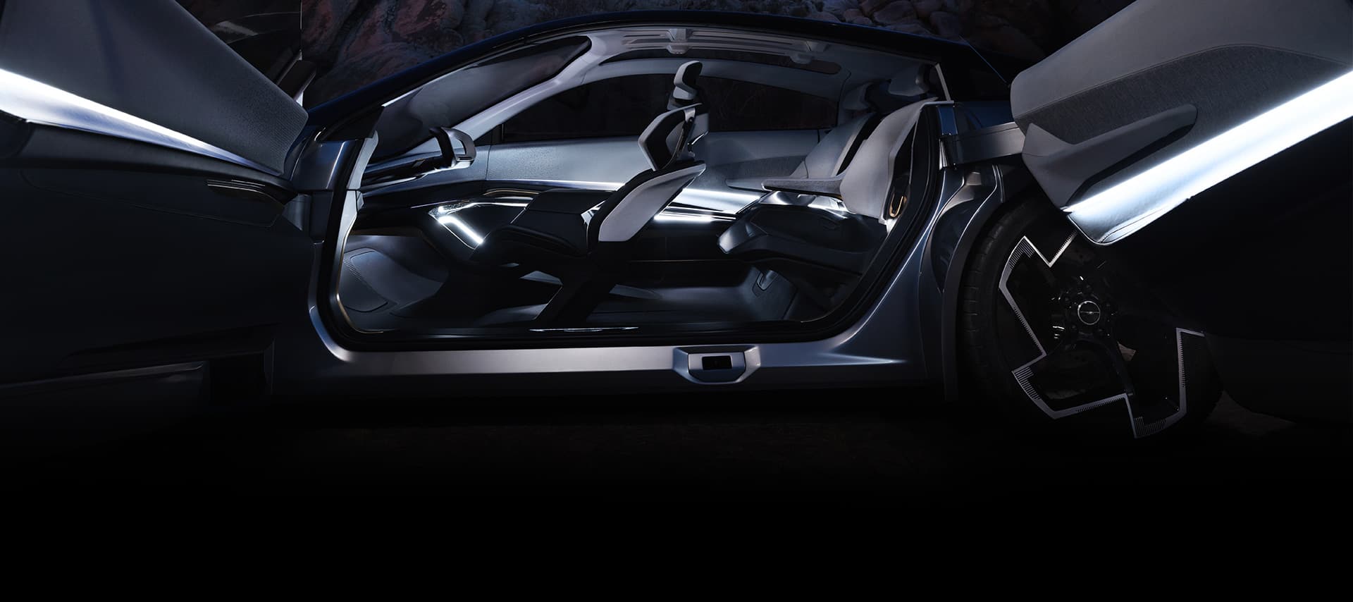 A driver-side profile of the Chrysler Halcyon Concept vehicle with its side doors open, focusing on the front and rear seats.